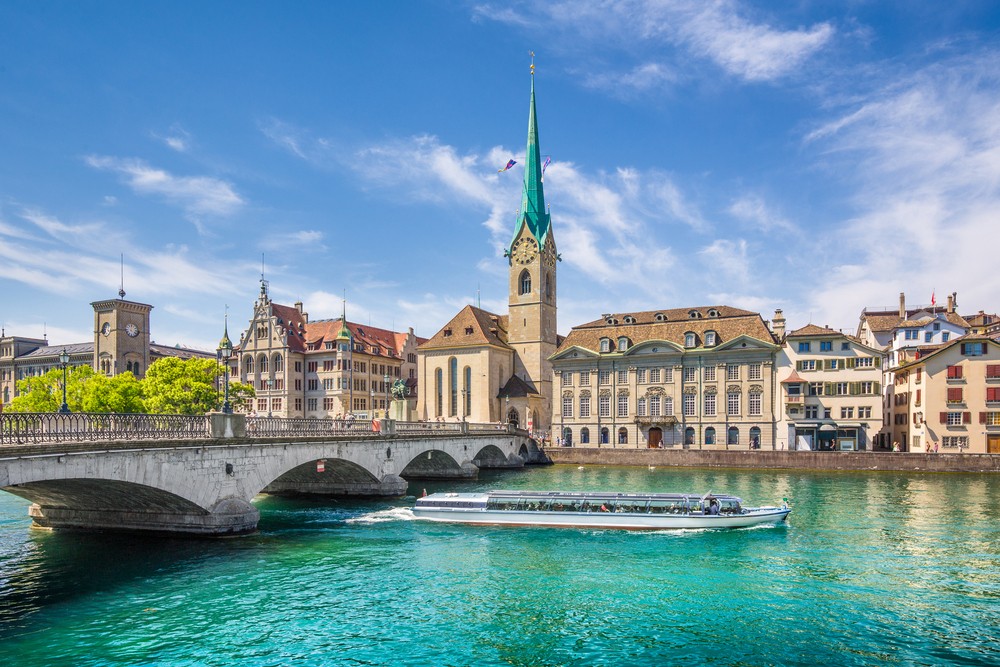 River with boat going under with church in background