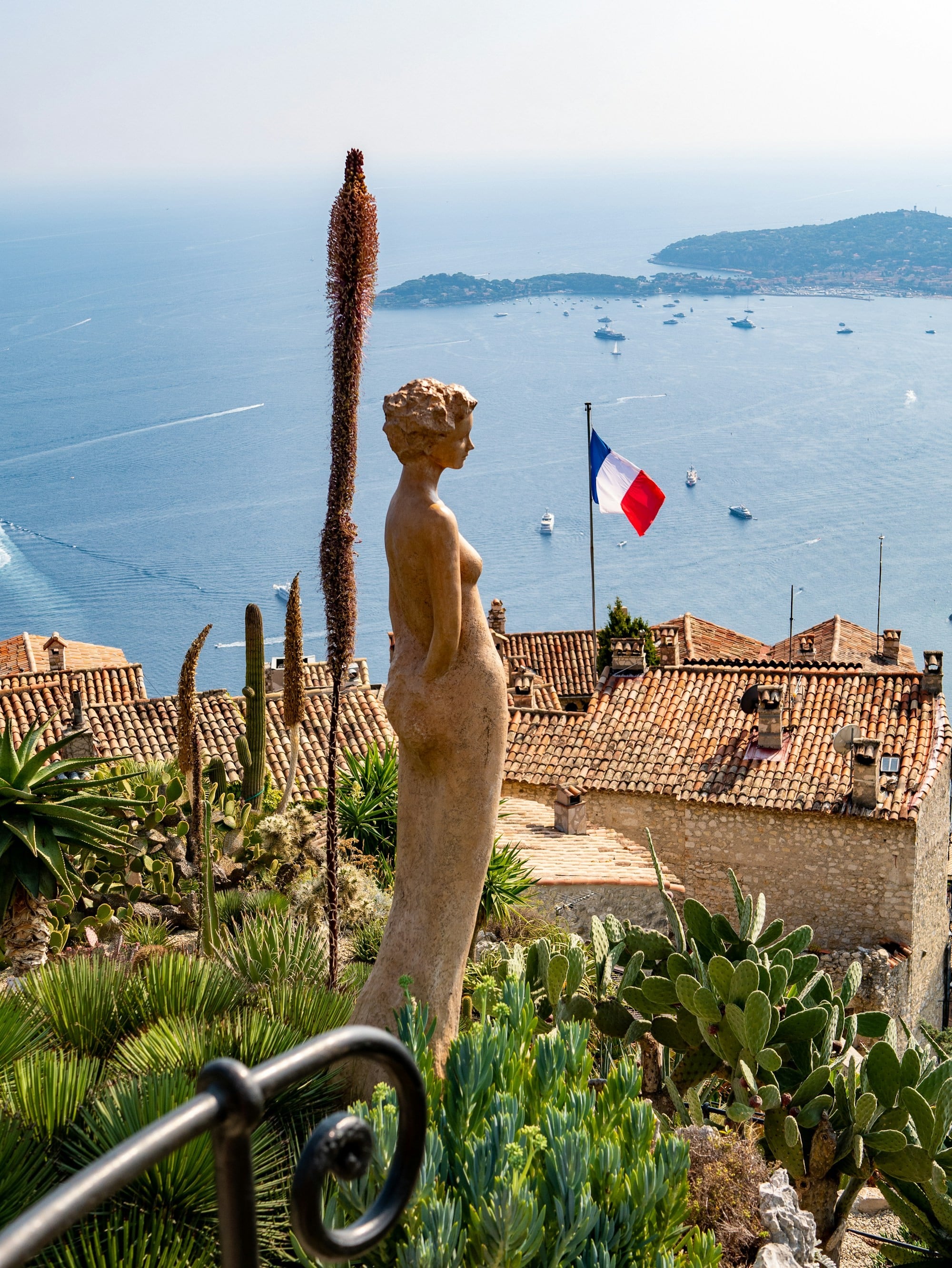 Woman statue overlooking water in france