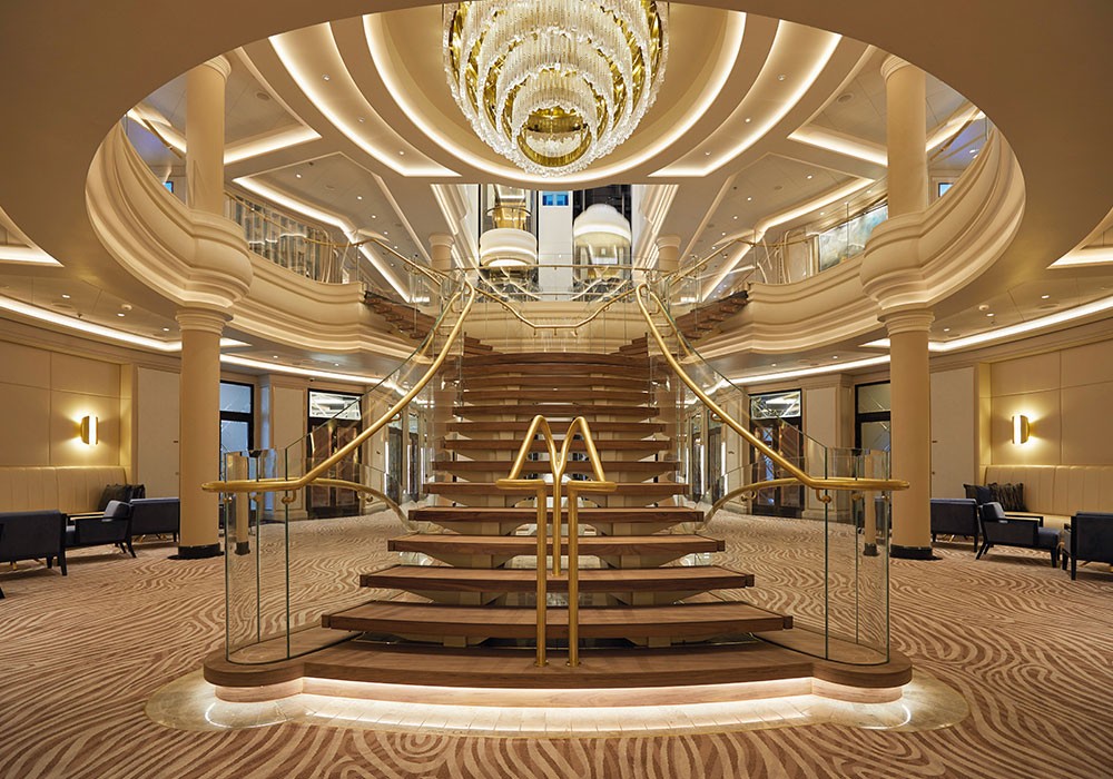 gold staircase in the middle of a cruise ship